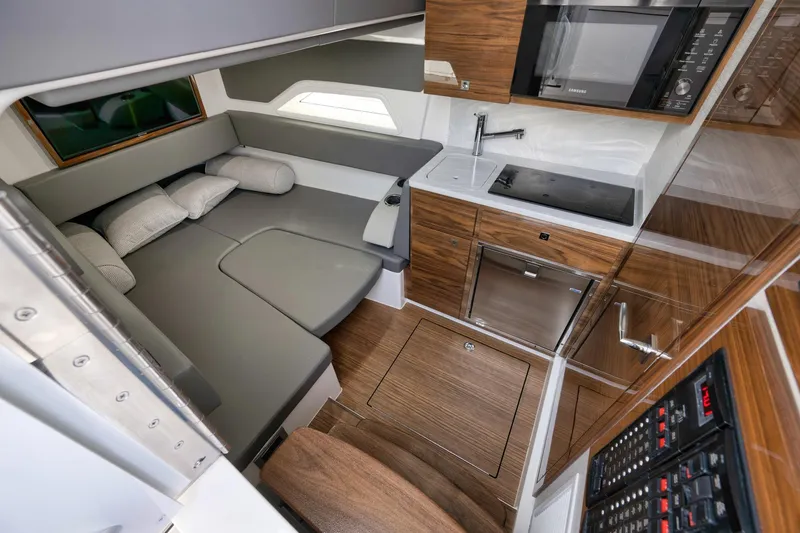 Slide: The Image of 2024 Valhalla V-46 cabin interior with modern kitchen and cozy seating area. - 6