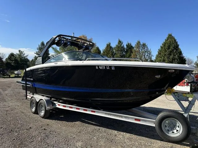 The Image of 2022 Chaparral 287 SSX boat on trailer, parked outdoors under clear blue sky. - 0