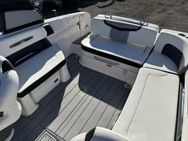 Slide: The Image of 2022 Chaparral 287 SSX boat interior with white seating and sleek design. - 10