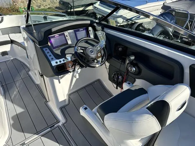 Slide: The Image of 2022 Chaparral 287 SSX boat cockpit with modern controls and steering wheel. - 11