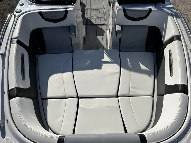 Slide: The Image of 2022 Chaparral 287 SSX boat interior with white cushioned seating. - 17