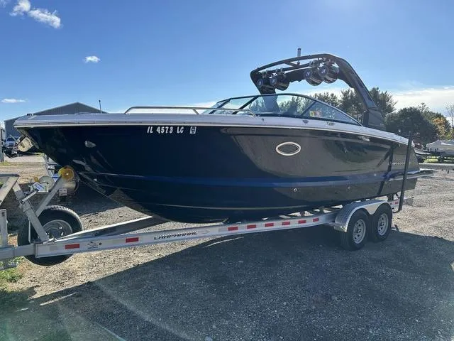 Slide: The Image of 2022 Chaparral 287 SSX boat on trailer under clear blue sky. - 2