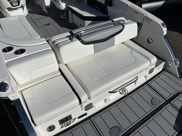 Slide: The Image of 2022 Chaparral 287 SSX boat with sleek white seating and modern deck design. - 5