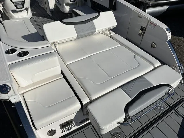 Slide: The Image of 2022 Chaparral 287 SSX boat interior with white seating and cup holders. - 6