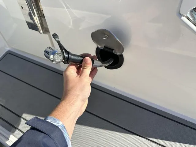 Slide: The Image of Hand holding a fuel nozzle at Chaparral 287 SSX boat, 2022 model. - 8