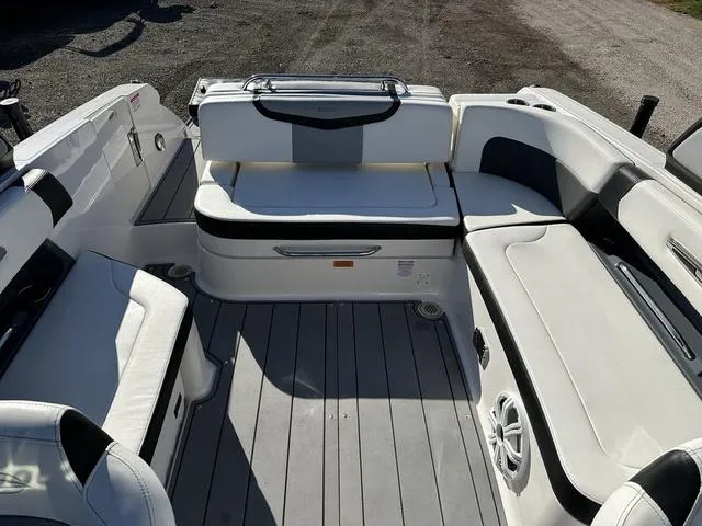 Slide: The Image of 2022 Chaparral 287 SSX boat interior with white seating and gray flooring. - 9