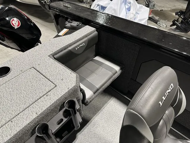 Slide: The Image of 2025 Lund 1875 Fisherman Sport boat interior with seating and storage compartments. - 10