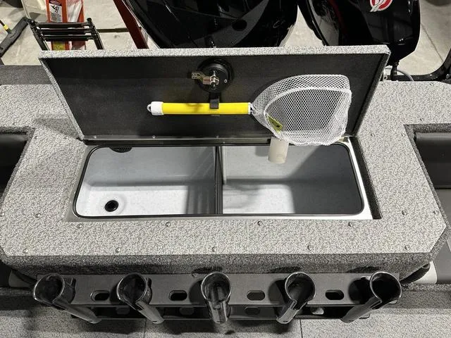 Slide: The Image of 2025 Lund 1875 Fisherman Sport boat with open storage compartment and fishing net. - 11