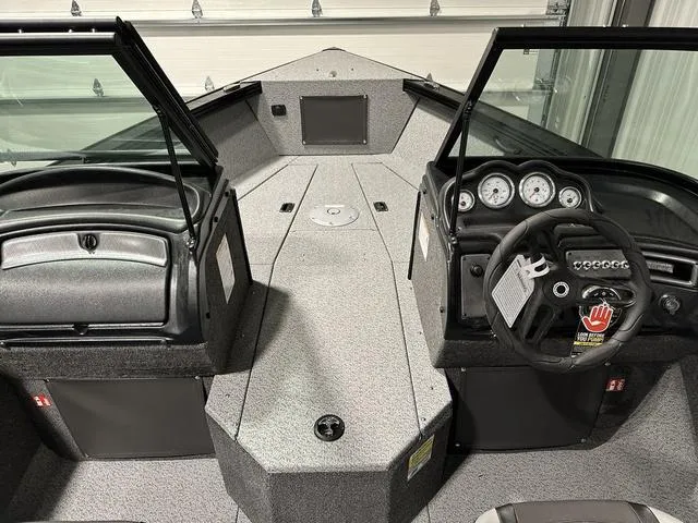 Slide: The Image of 2025 Lund 1875 Fisherman Sport boat interior with dual consoles and steering wheel. - 14