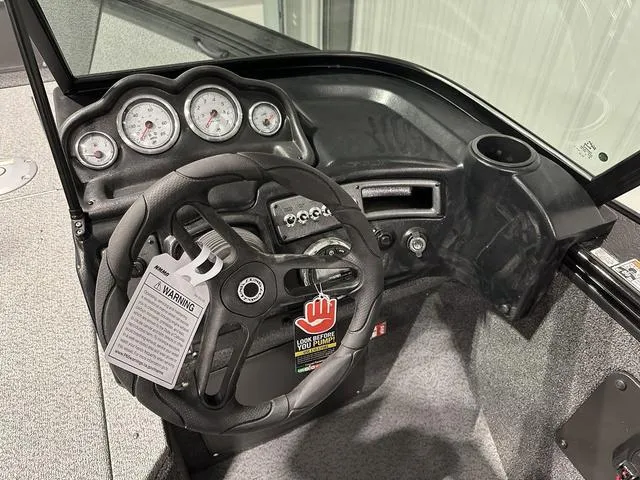 Slide: The Image of 2025 Lund 1875 Fisherman Sport dashboard with steering wheel and gauges. - 16