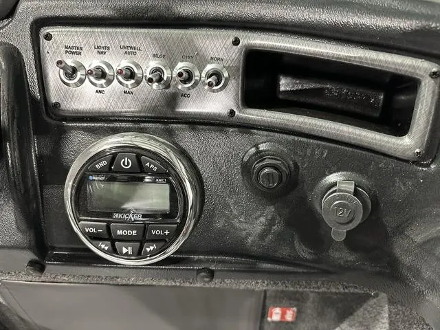 Slide: The Image of Control panel of 2025 Lund 1875 Fisherman Sport boat with switches and audio system. - 17