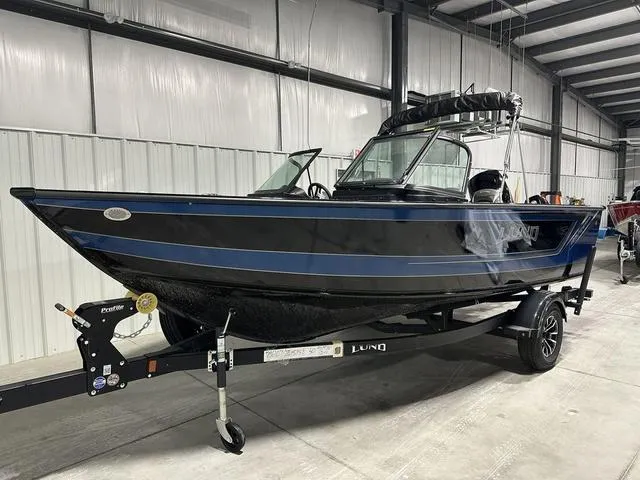 Slide: The Image of 2025 Lund 1875 Fisherman Sport boat on trailer in indoor storage facility. - 2