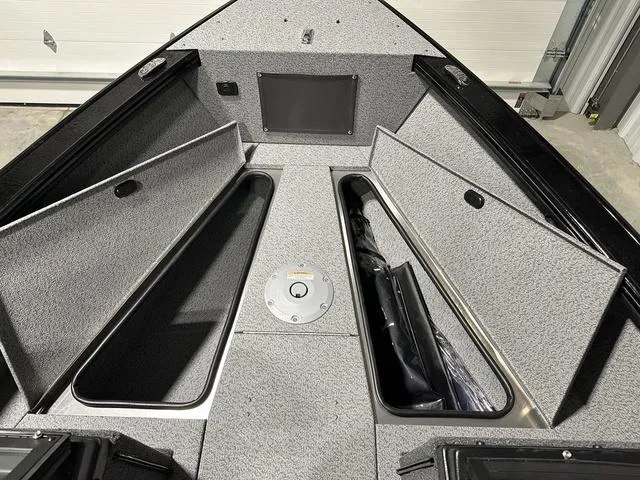 Slide: The Image of 2025 Lund 1875 Fisherman Sport boat interior with open storage compartments. - 20