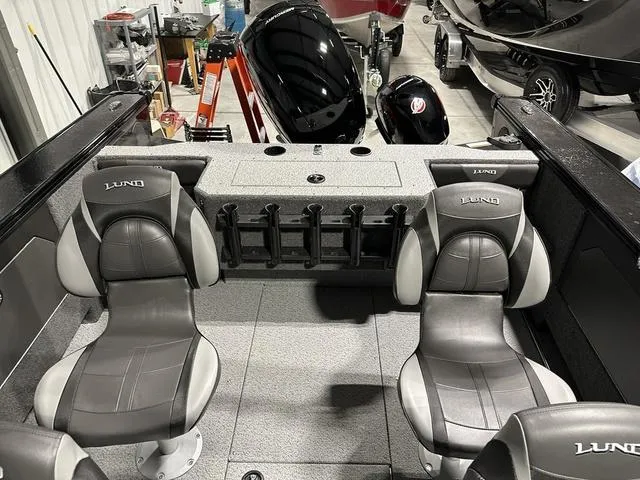 Slide: The Image of 2025 Lund 1875 Fisherman Sport boat interior with two seats and storage compartments. - 8