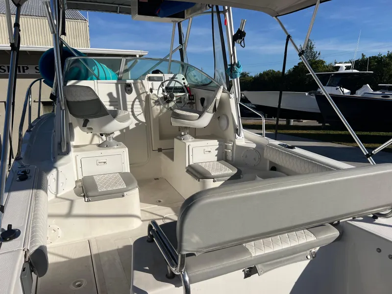Slide: The Image of 2000 Robalo 2440 Walkaround boat interior with seating and steering console. - 11