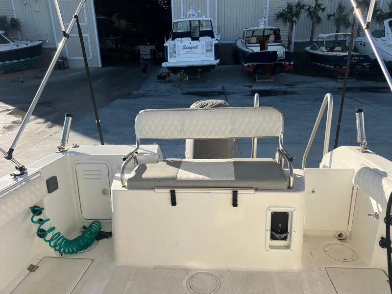 Slide: The Image of 2000 Robalo 2440 Walkaround boat interior with seating and storage. - 18