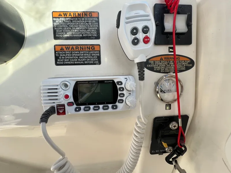 Slide: The Image of Boat control panel with radio and warning labels, Robalo 2440 Walkaround, 2000 model. - 23