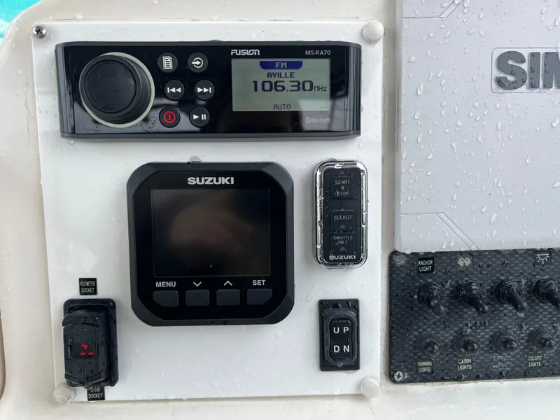 Slide: The Image of Boat dashboard with Suzuki controls and Fusion radio, Robalo 2440 Walkaround, 2000 model. - 24