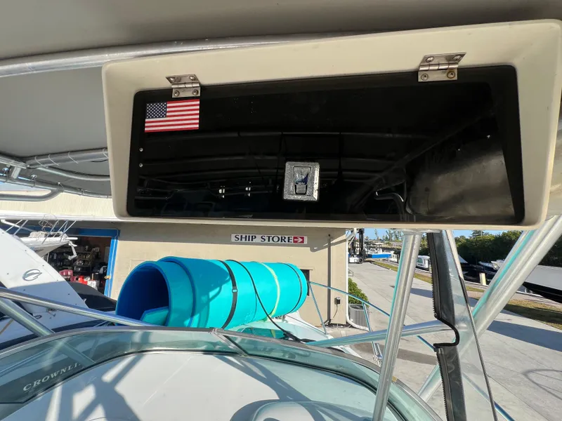 Slide: The Image of Robalo 2440 Walkaround 2000 boat with American flag sticker, near ship store. - 31