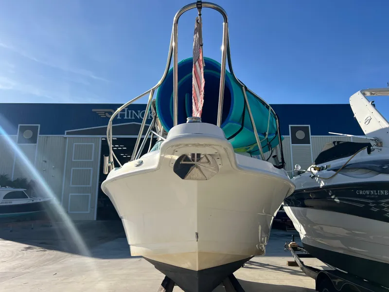 Slide: The Image of 2000 Robalo 2440 Walkaround boat in marina, front view, sunny day. - 6