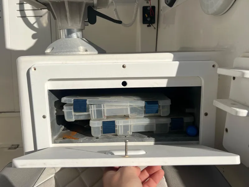 Slide: The Image of Storage compartment on a 2000 Robalo 2440 Walkaround boat with tackle boxes inside. - 7