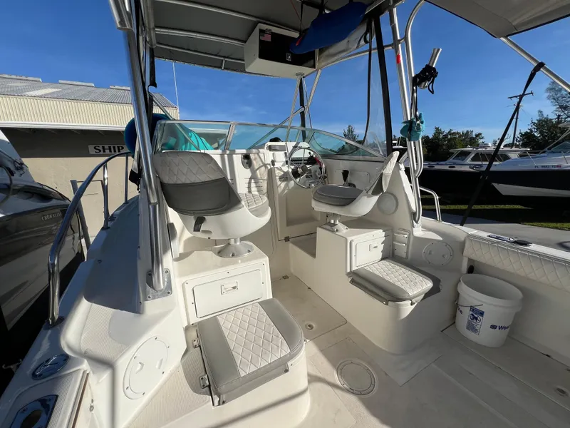 Slide: The Image of 2000 Robalo 2440 Walkaround boat interior with seating and steering console. - 8