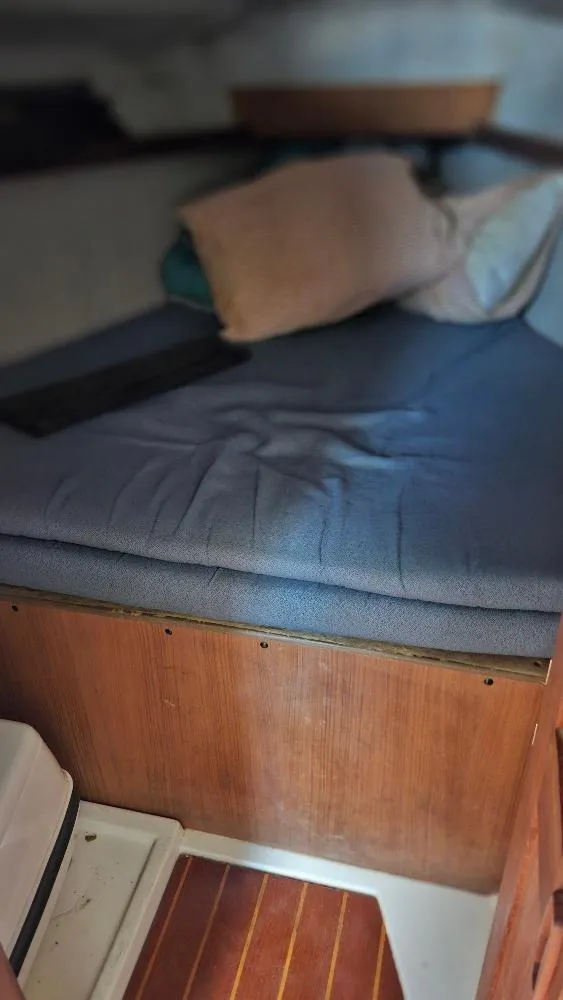 Slide: The Image of Cozy cabin interior of a 1987 Hunter 26.5 sailboat with a cushioned bed. - 12