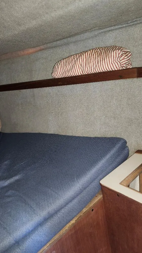 Slide: The Image of Interior cabin of 1987 Hunter 26.5 sailboat with blue mattress and striped pillow. - 14