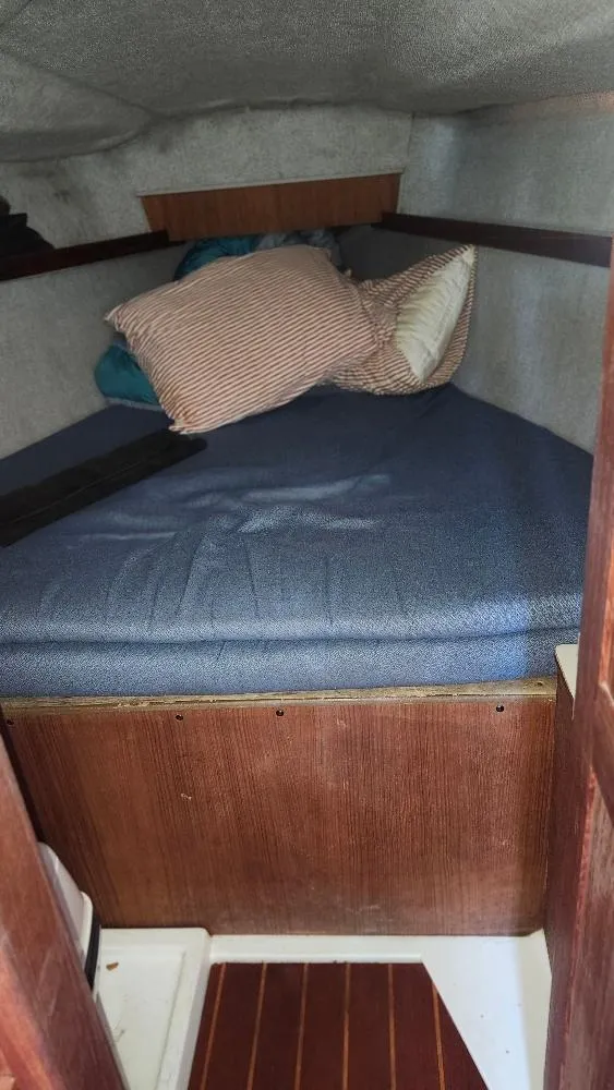 Slide: The Image of Cozy cabin interior of 1987 Hunter 26.5 sailboat with bed and pillows. - 15