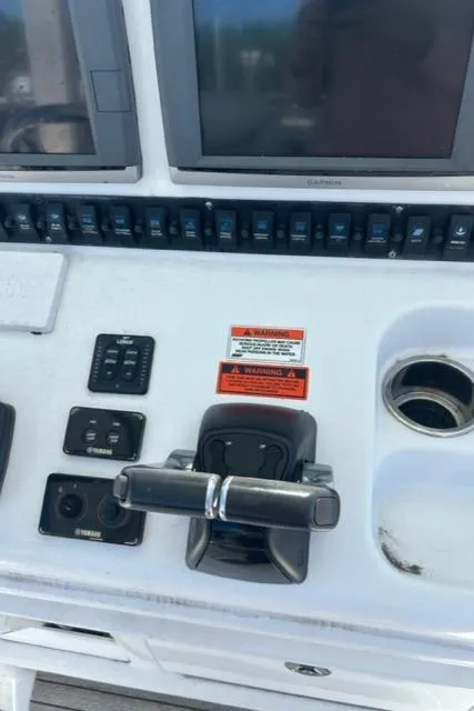 Slide: The Image of 2014 Sea Hunt Gamefish 27 control panel with dual screens and throttle. - 10
