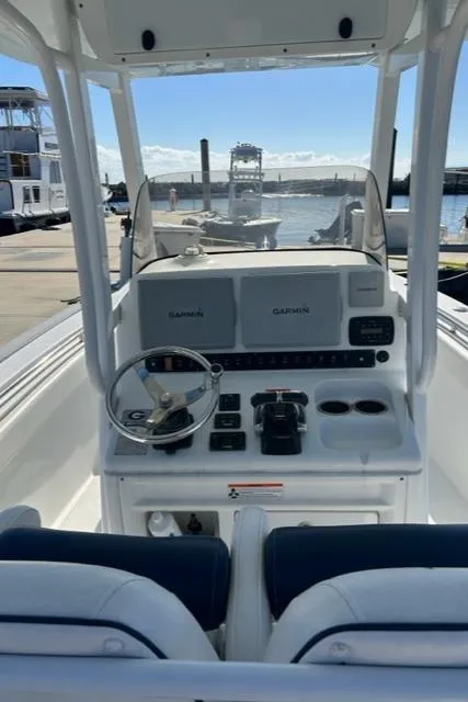 Slide: The Image of 2014 Sea Hunt Gamefish 27 helm with Garmin electronics, docked at marina. - 11
