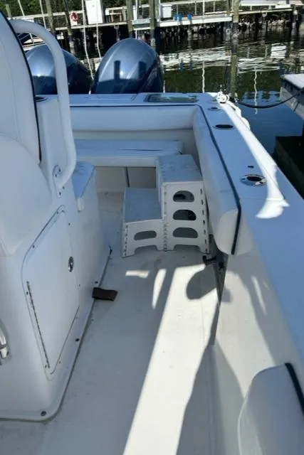 Slide: The Image of 2014 Sea Hunt Gamefish 27 boat interior with forward seating and storage compartments. - 12