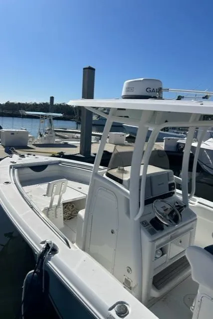 Slide: The Image of 2014 Sea Hunt Gamefish 27 boat with forward seating, docked at marina. - 13
