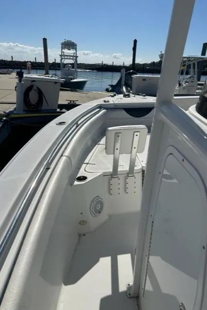Slide: The Image of 2014 Sea Hunt Gamefish 27 boat docked, featuring forward seating and sleek design. - 15