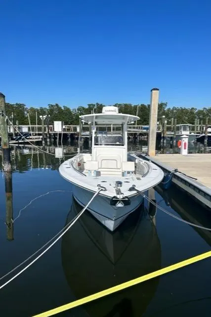 Slide: The Image of 2014 Sea Hunt Gamefish 27 boat docked in marina under clear blue sky. - 3