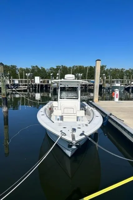 Slide: The Image of 2014 Sea Hunt Gamefish 27 boat docked in marina under clear blue sky. - 6