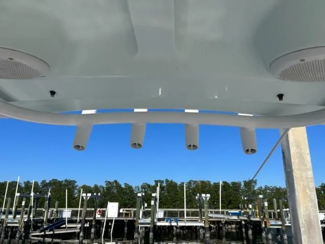 Slide: The Image of 2014 Sea Hunt Gamefish 27 boat with rod holders, docked at marina. - 8