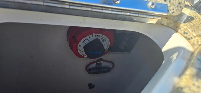 Slide: The Image of Battery switch inside a 2010 Monterey 254FS boat compartment. - 12