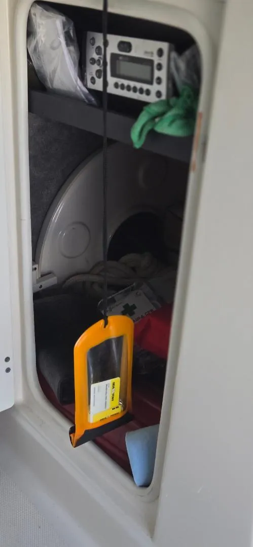 Slide: The Image of Storage compartment in a 2010 Monterey 254FS boat with radio and safety equipment. - 17