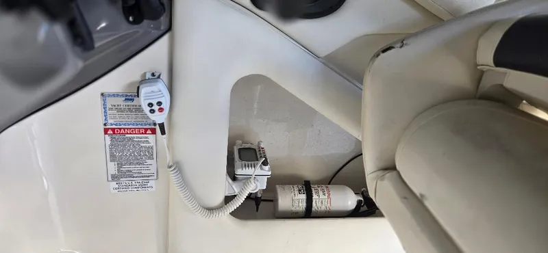 Slide: The Image of 2010 Monterey 254FS boat interior with safety equipment and control panel. - 18