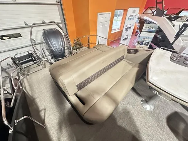 Slide: The Image of 2025 Bennington 24 LXSB boat interior with beige seating and modern design. - 11