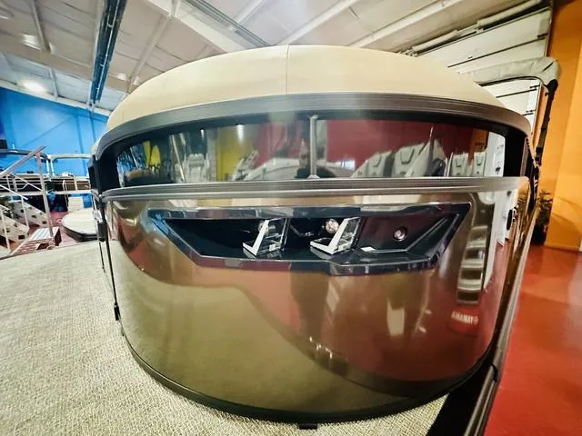 Slide: The Image of 2025 Bennington 24 LXSB pontoon boat front view in showroom. - 4