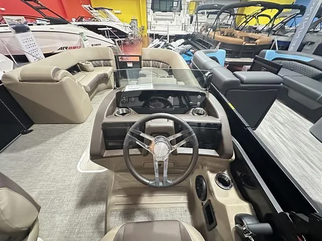 Slide: The Image of 2025 Bennington 24 LXSB boat interior with modern steering and seating. - 7