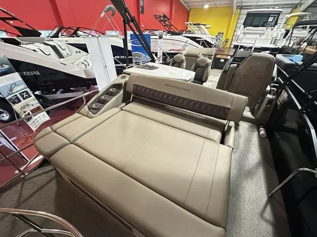 Slide: The Image of 2025 Bennington 24 LXSB luxury pontoon boat interior at a showroom display. - 8