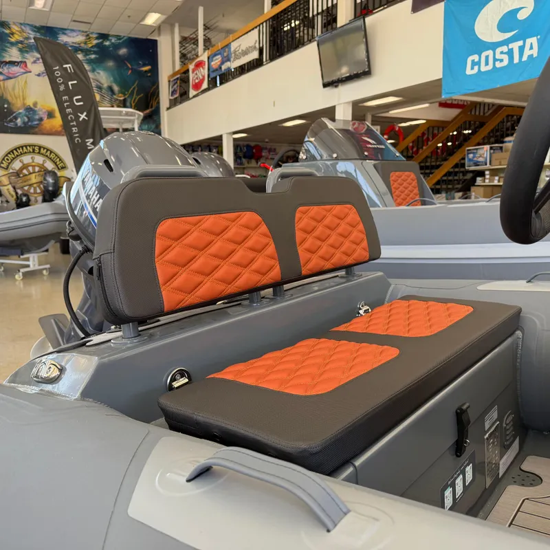 Slide: The Image of Highfield Sport 360 boat interior with orange quilted seats, showroom display, 2025 model. - 10