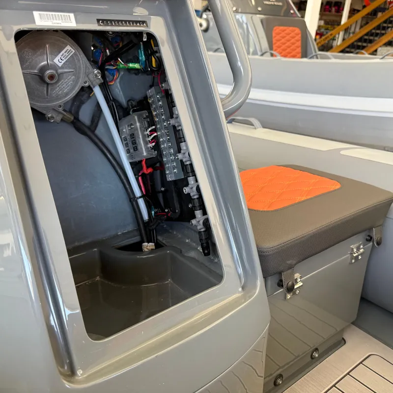 Slide: The Image of 2025 Highfield Sport 360 boat interior showing open electrical panel and seating. - 12