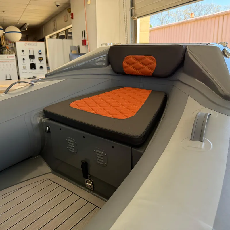 Slide: The Image of 2025 Highfield Sport 360 boat interior with orange and black cushioned seating. - 13