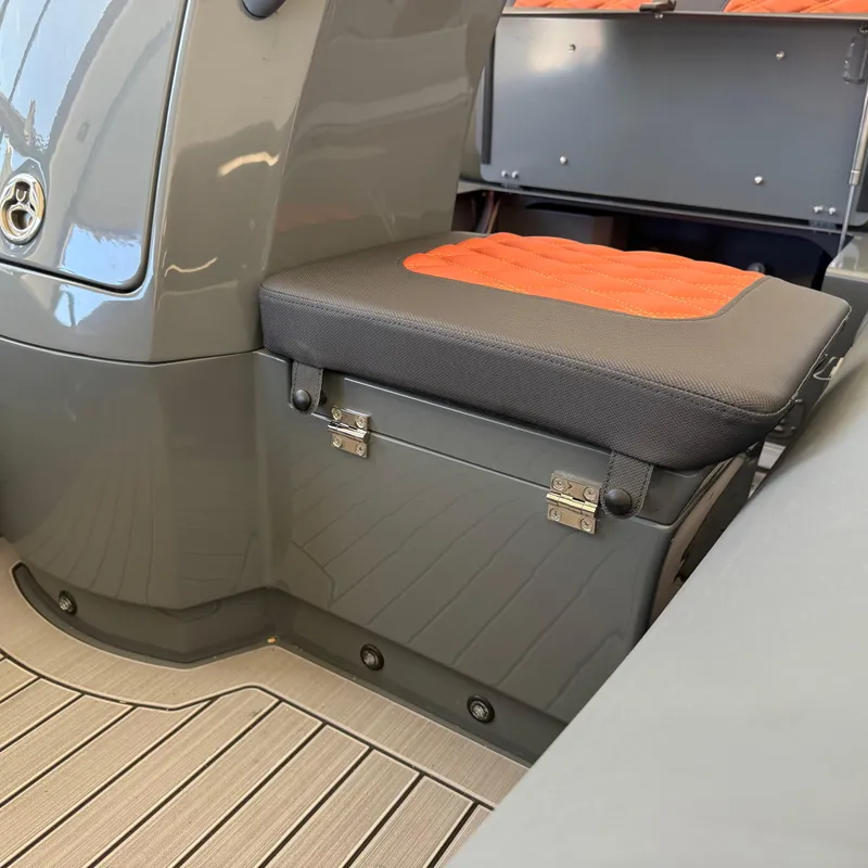 Slide: The Image of 2025 Highfield Sport 360 boat interior with cushioned seat and storage compartment. - 14