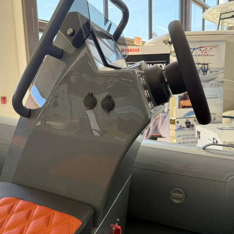 Slide: The Image of 2025 Highfield Sport 360 boat console with steering wheel and controls. - 15
