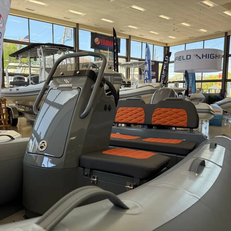 Slide: The Image of 2025 Highfield Sport 360 boat displayed indoors on a trailer. - 3